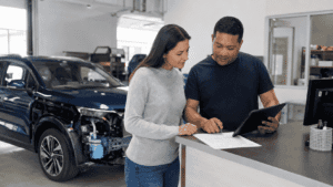 Customer reviewing a repair estimate with a service advisor at an auto repair facility